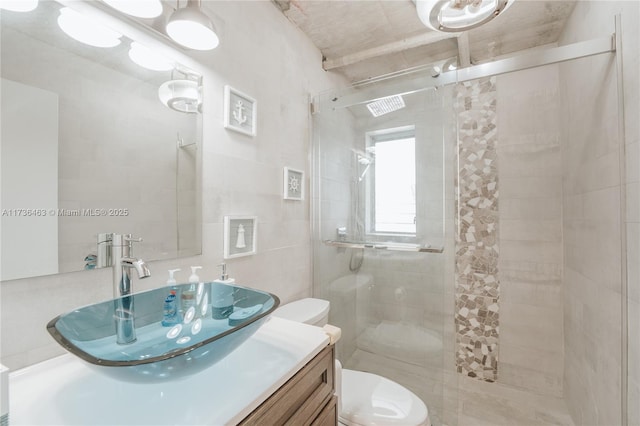 bathroom featuring vanity, tile walls, an enclosed shower, and toilet