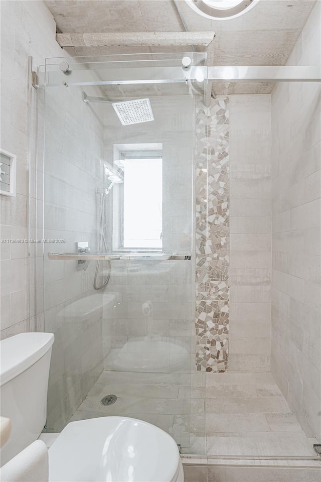 bathroom with an enclosed shower and toilet