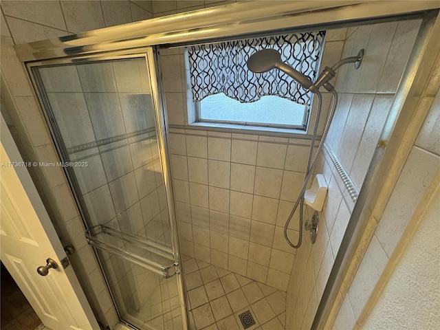 bathroom with a shower with door