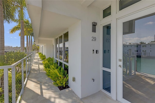 view of exterior entry featuring a balcony