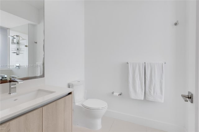 bathroom featuring vanity, toilet, tile patterned flooring, and a shower