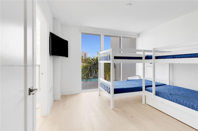 bedroom featuring access to exterior and light hardwood / wood-style floors