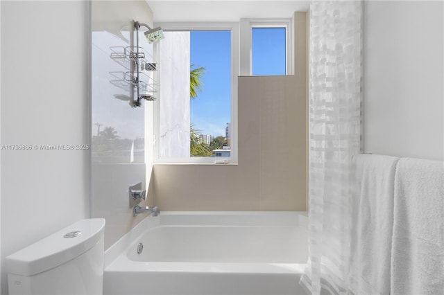 bathroom featuring a tub and toilet