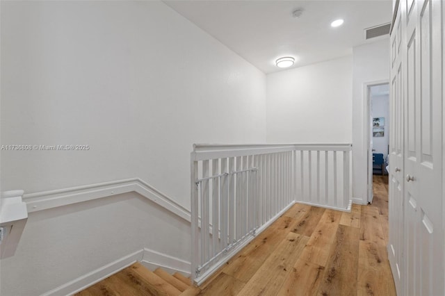 corridor with hardwood / wood-style floors