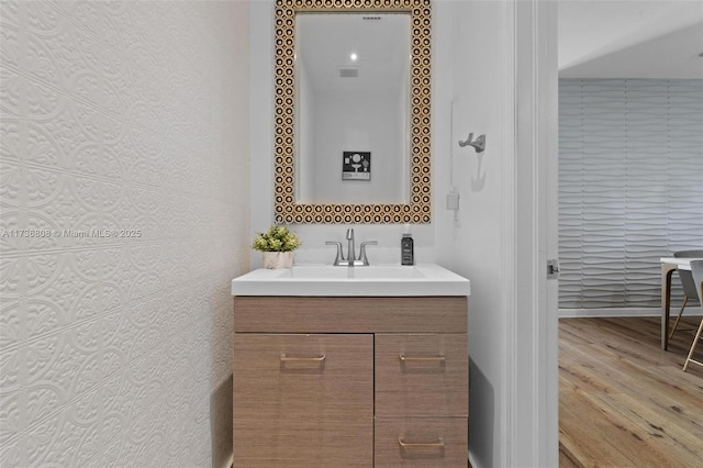 bathroom with wood-type flooring and vanity