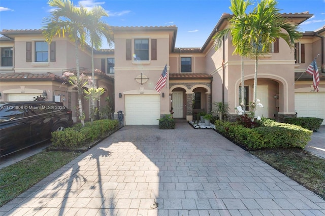 mediterranean / spanish-style house with a garage