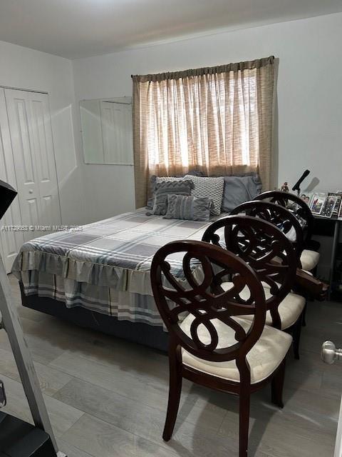 bedroom featuring multiple windows and a closet