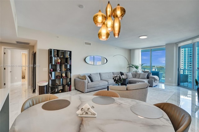 living room with an inviting chandelier and floor to ceiling windows