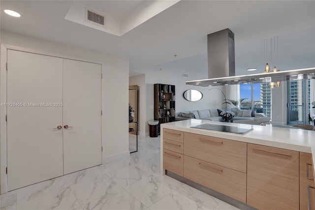 kitchen with pendant lighting, light brown cabinetry, and black electric cooktop