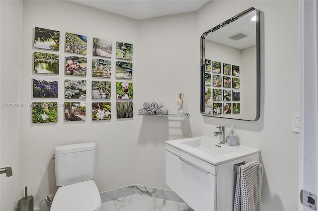 bathroom featuring vanity and toilet