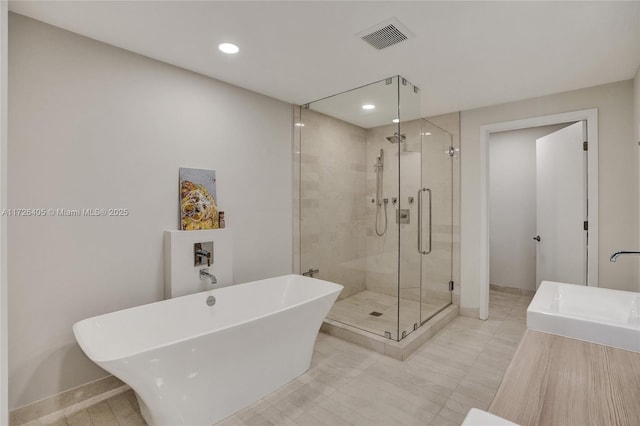 bathroom featuring sink and shower with separate bathtub