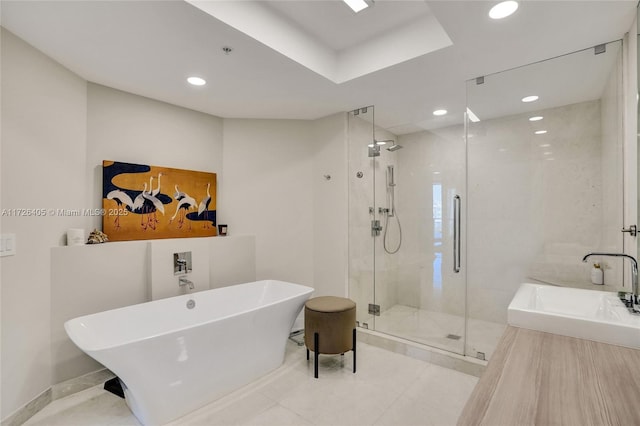 bathroom featuring separate shower and tub and sink