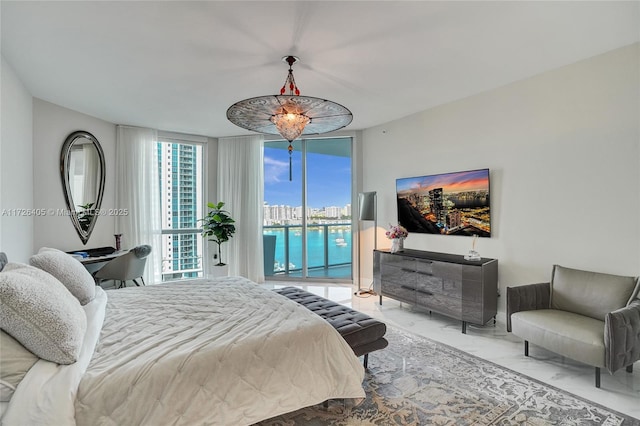 bedroom with floor to ceiling windows and access to exterior