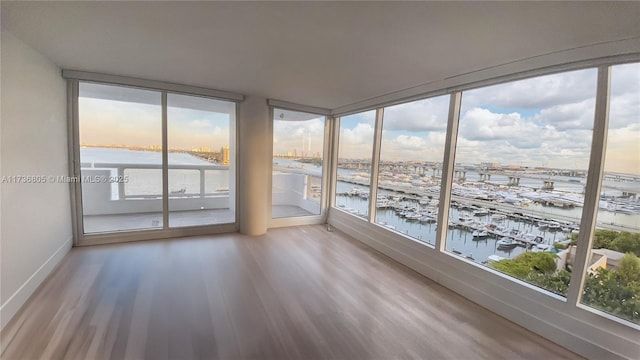 unfurnished sunroom featuring a water view