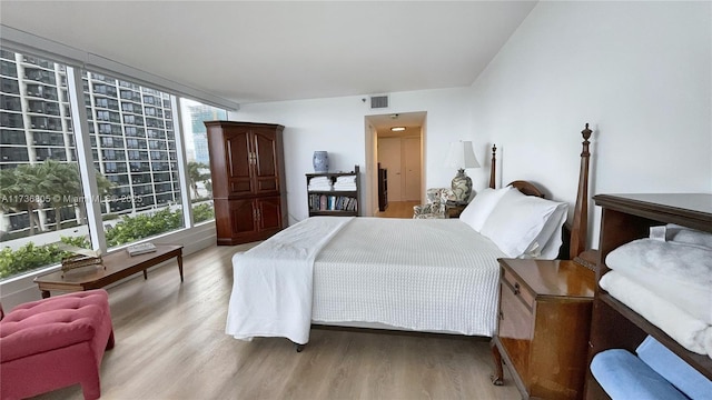 bedroom featuring light wood finished floors, multiple windows, and visible vents