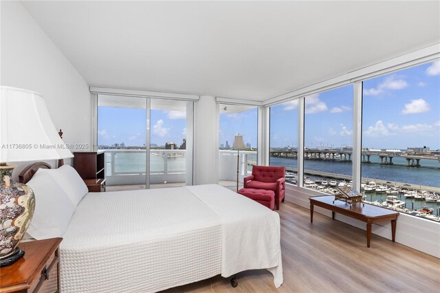 1717 N Bayshore Dr Unit A-1231, Miami, FL 33132 - bedroom with a water view, light wood-style flooring, expansive windows, and view of marina