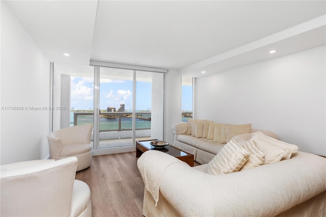 1717 N Bayshore Dr Unit A-1231, Miami, FL 33132 - living room with wood finished floors, a water view, floor to ceiling windows, and recessed lighting