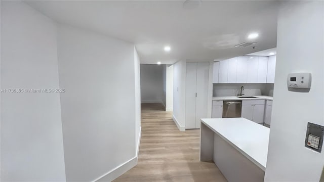 1717 N Bayshore Dr Unit A-1231, Miami, FL 33132 - kitchen featuring stainless steel dishwasher, white cabinets, light countertops, modern cabinets, and light wood finished floors