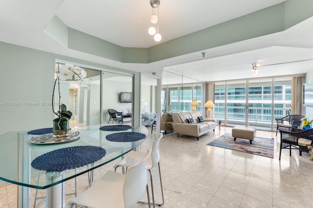 dining space with expansive windows and light tile patterned flooring