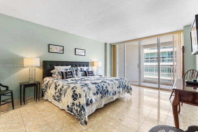 bedroom featuring access to exterior, light tile patterned floors, and floor to ceiling windows