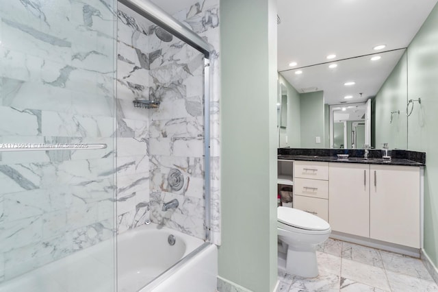 full bathroom featuring vanity, shower / bath combination with glass door, and toilet