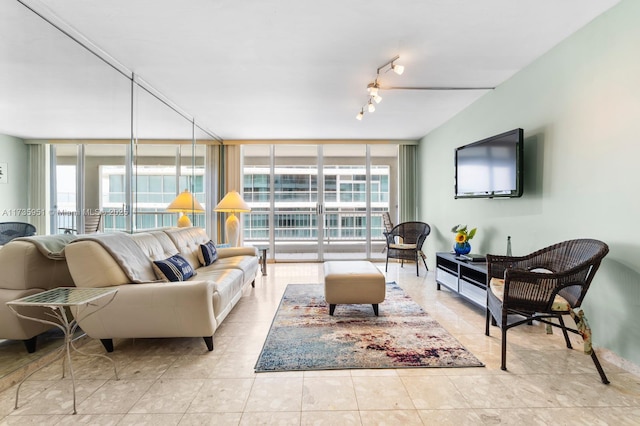 living room with floor to ceiling windows, plenty of natural light, light tile patterned floors, and rail lighting