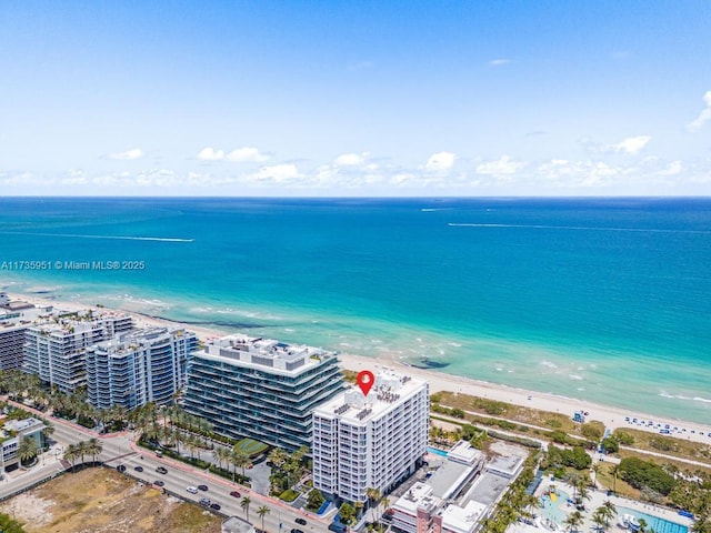 birds eye view of property featuring a view of the beach and a water view