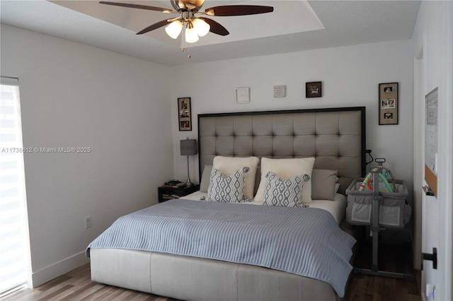 bedroom with ceiling fan and light hardwood / wood-style floors