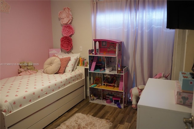 bedroom with dark hardwood / wood-style floors