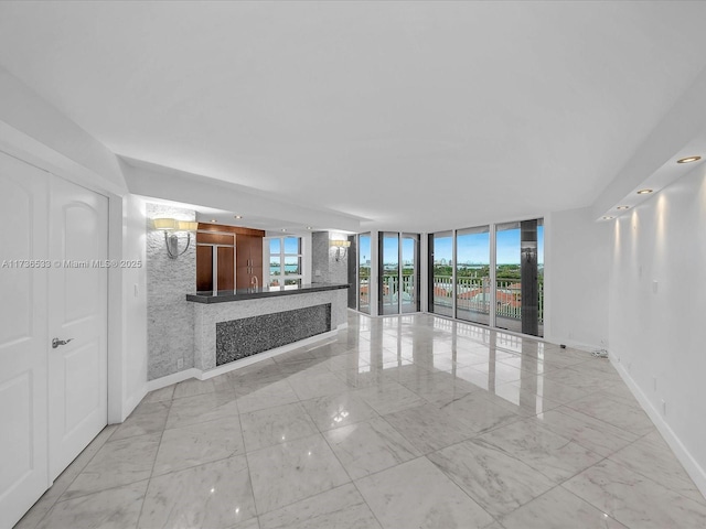 unfurnished living room with expansive windows