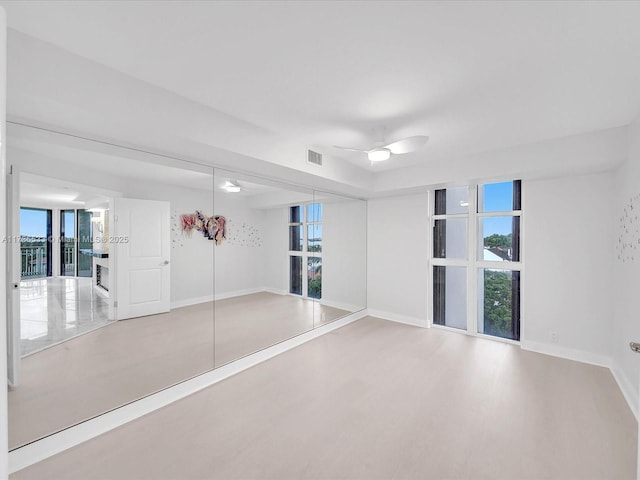 empty room featuring wood-type flooring and ceiling fan