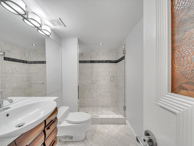 bathroom with vanity, toilet, and a shower with door