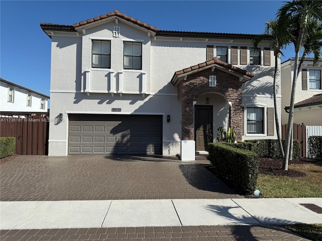 mediterranean / spanish-style house with a garage