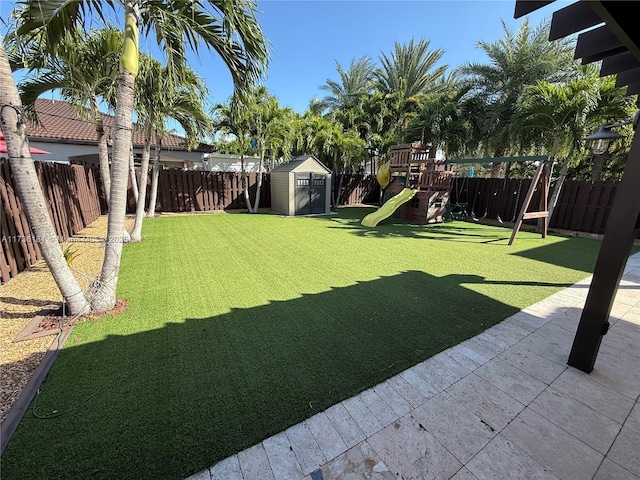 view of yard with a shed and a playground