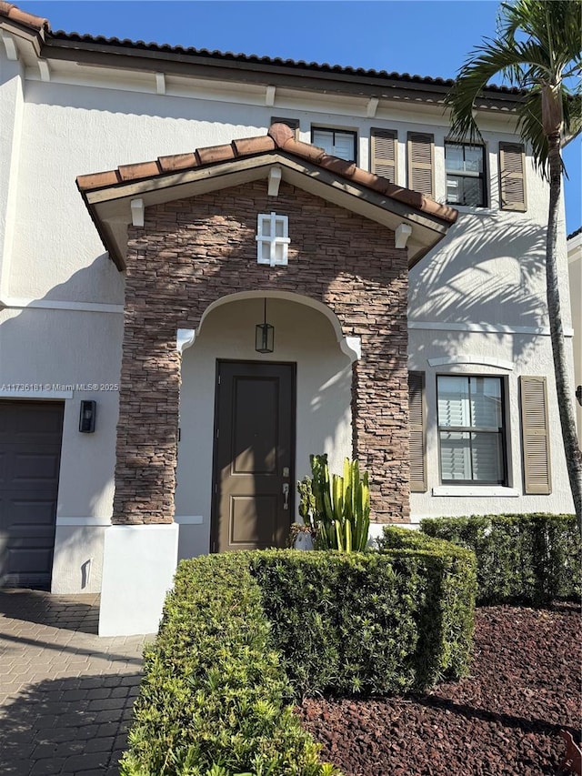 doorway to property with a garage