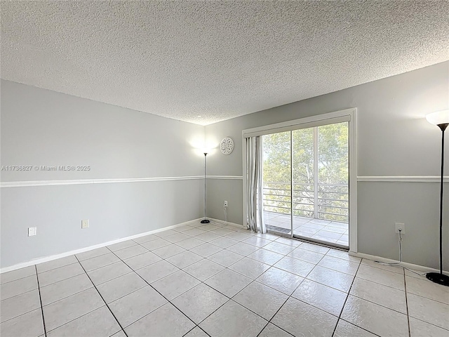 tiled spare room with a textured ceiling