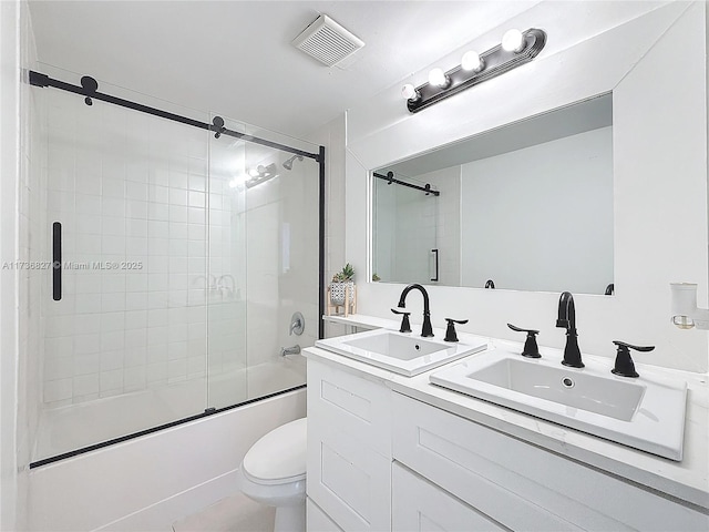 full bathroom with shower / bath combination with glass door, vanity, and toilet