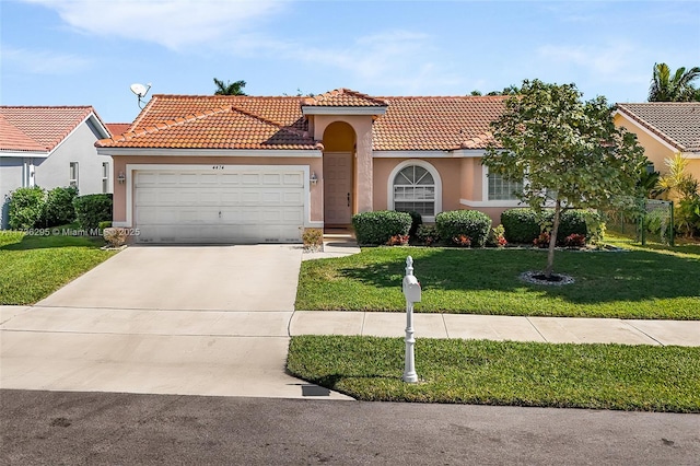 mediterranean / spanish house featuring a garage and a front yard