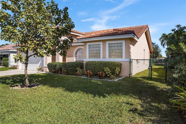 mediterranean / spanish home featuring stucco siding, concrete driveway, an attached garage, a front yard, and a tiled roof