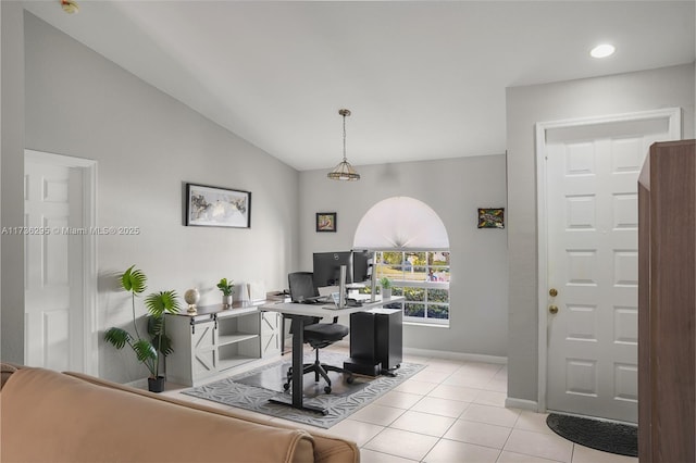 office featuring light tile patterned floors, baseboards, and vaulted ceiling