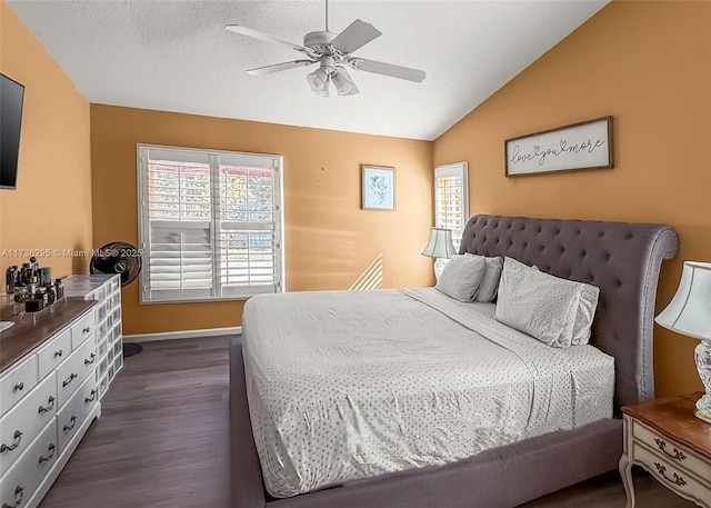 bedroom with vaulted ceiling, dark wood-style flooring, multiple windows, and a textured ceiling