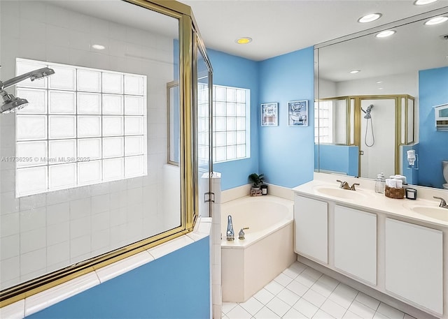 full bathroom featuring a stall shower, a garden tub, a sink, and double vanity