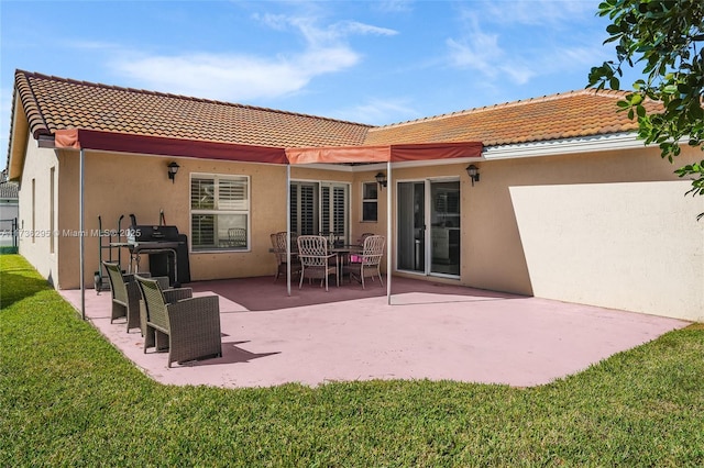 back of house featuring stucco siding, a yard, and a patio