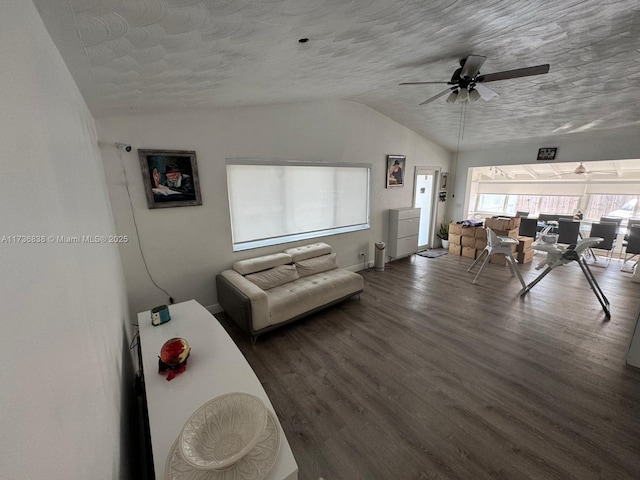 living room with dark wood-type flooring, ceiling fan, lofted ceiling, and a textured ceiling