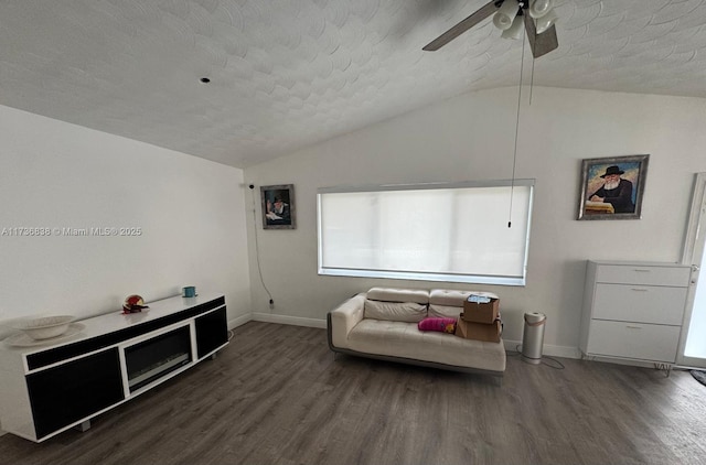 sitting room with lofted ceiling, ceiling fan, dark wood-type flooring, and a textured ceiling