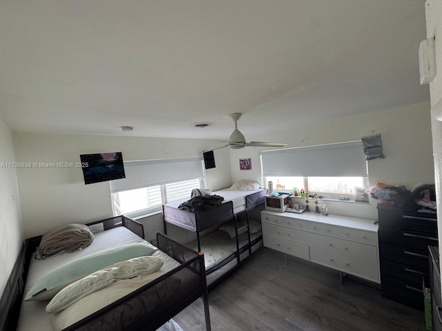 bedroom featuring ceiling fan, vaulted ceiling, and dark hardwood / wood-style flooring