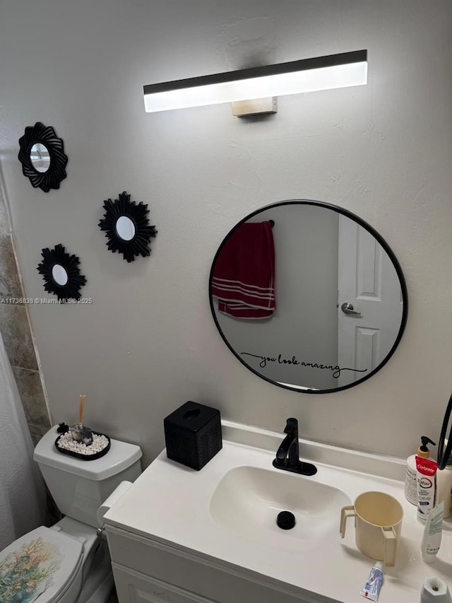 bathroom with vanity and toilet