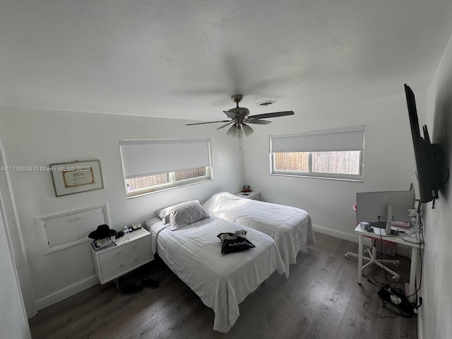 bedroom with ceiling fan and dark hardwood / wood-style flooring