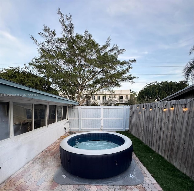 view of pool with a hot tub