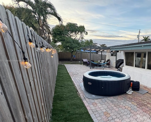 patio terrace at dusk with a hot tub